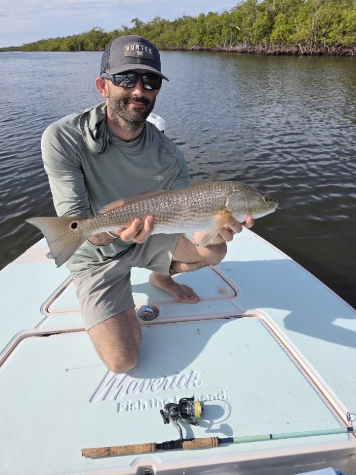 Dan holding a redfish on a fishing charter